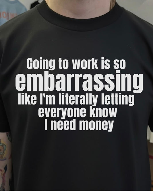 Black t-shirt with white text on a person wearing it.