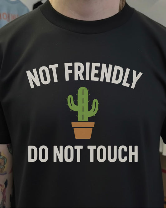 Black t-shirt with a cactus graphic and text 'Not Friendly Do Not Touch' on a plain background.