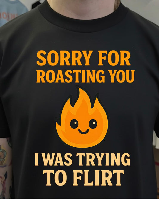 Black t-shirt with orange text and flame graphic worn by a person.