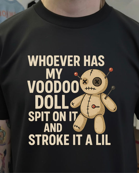 Black t-shirt with a voodoo doll graphic and text on a plain background